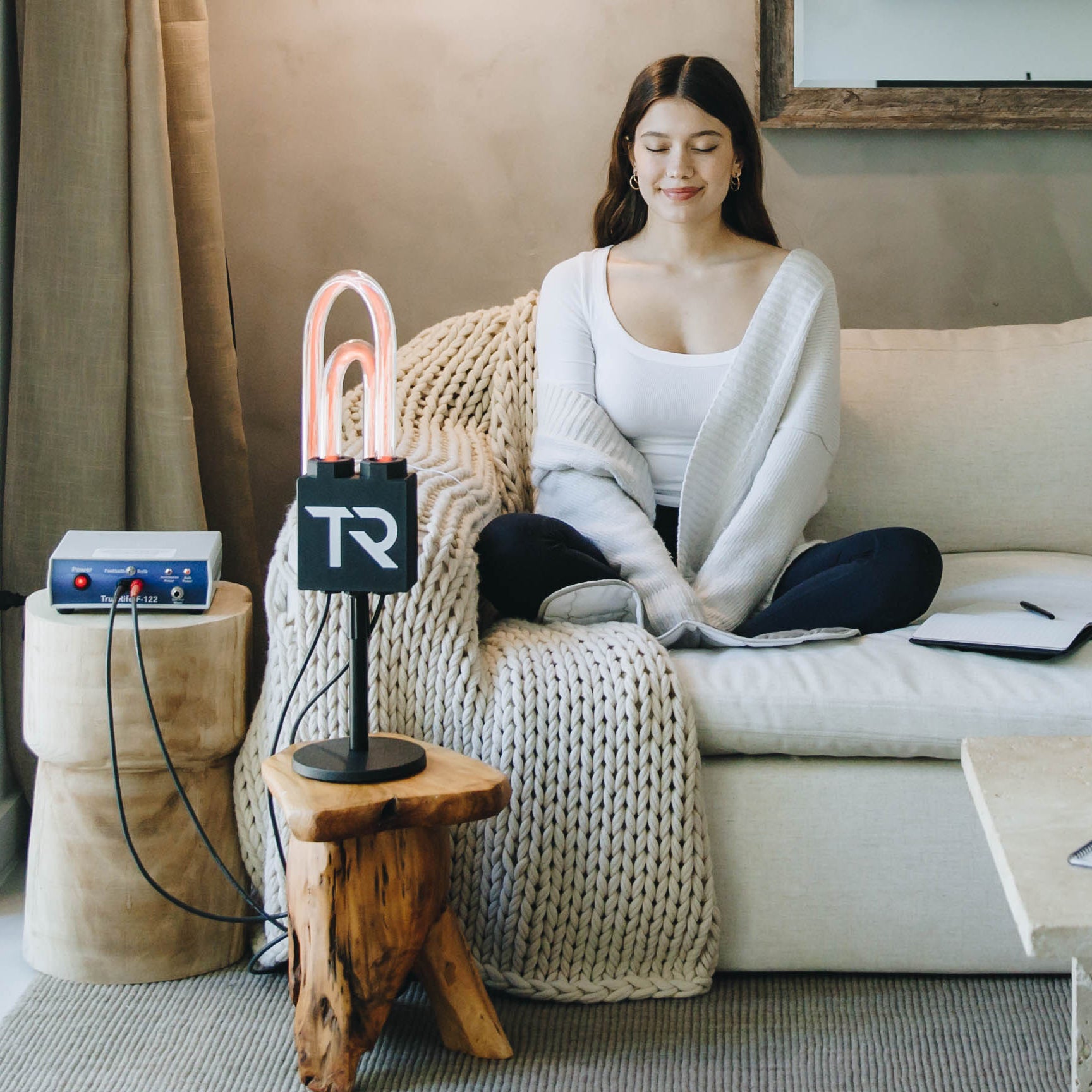 Woman relaxing on a couch during a SuperNova session